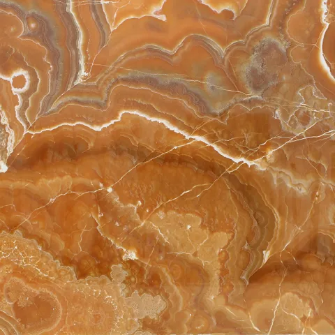 ONYX WAVY ORANGE — яркий полупрозрачный оникс с волнистыми оранжево-янтарными прожилками, идеально подходит для подсвеченных интерьерных акцентов и декоративных панелей